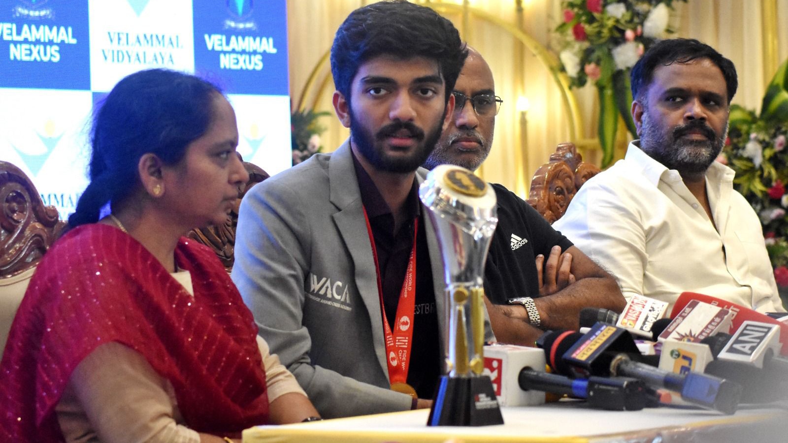 MVM Velmohan (right), owner of the Velammal School, with Gukesh and his parents. Photo By Special Arrangement