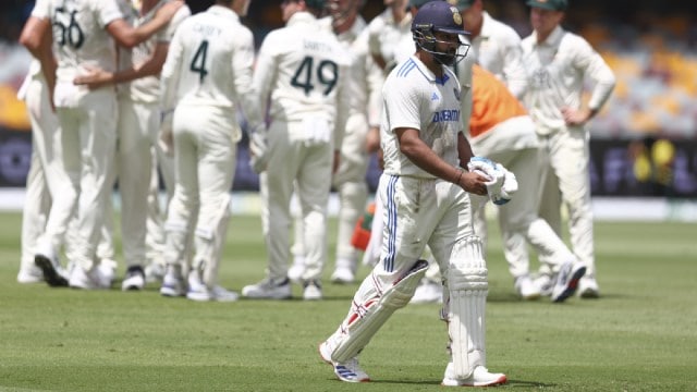 ndia's captain Rohit Sharma walks from the field after he was dismissed during play on day four of the third cricket test between India and Australia at the Gabba in Brisbane, Australia. (AP)