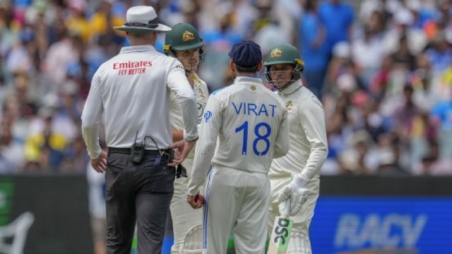 India's Virat Kohli, talks to Australia's Sam Konstas (second left) as Usman Khawaja (right) looks on during the first day of the fourth Test at the Melbourne Cricket Ground. (AP Photo)