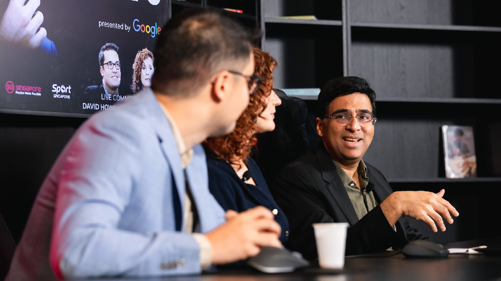 Viswanathan Anand in the FIDE commentary box with GM David Howell and IM Jovanka Houska during Game 6 of the World Chess Championship between Gukesh and Ding Liren. (PHOTO: Eng Chin An via FIDE Flickr)