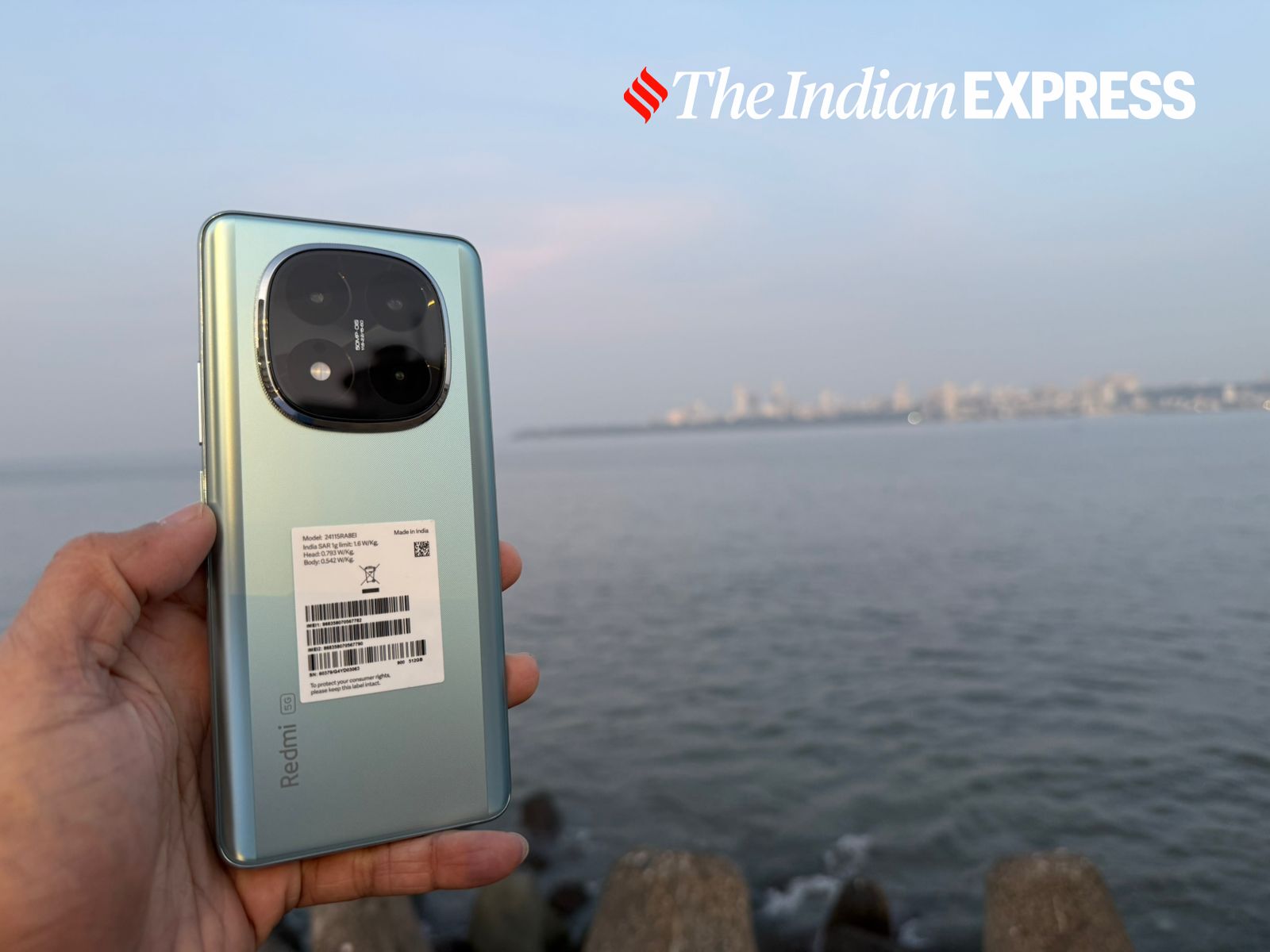 The Redmi Note 14 Pro+ 5G flaunts its distinct camera module and elegant design, perfectly complemented by the backdrop of the Mumbai skyline. (Image: Nandagopal Rajan/The Indian Express)