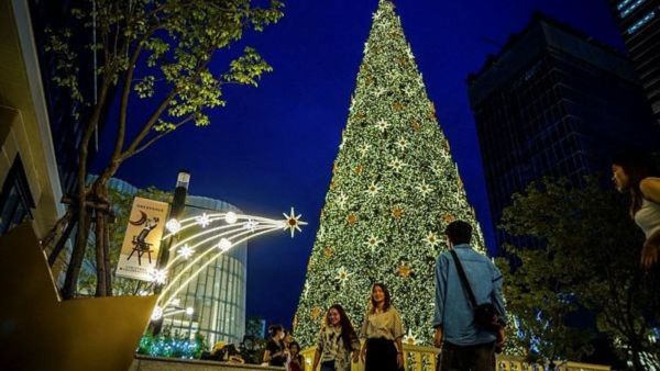 People gather next to Christmas decorations at a department store in Bangkok, Thailand. (Photo: Reuters/Representative)