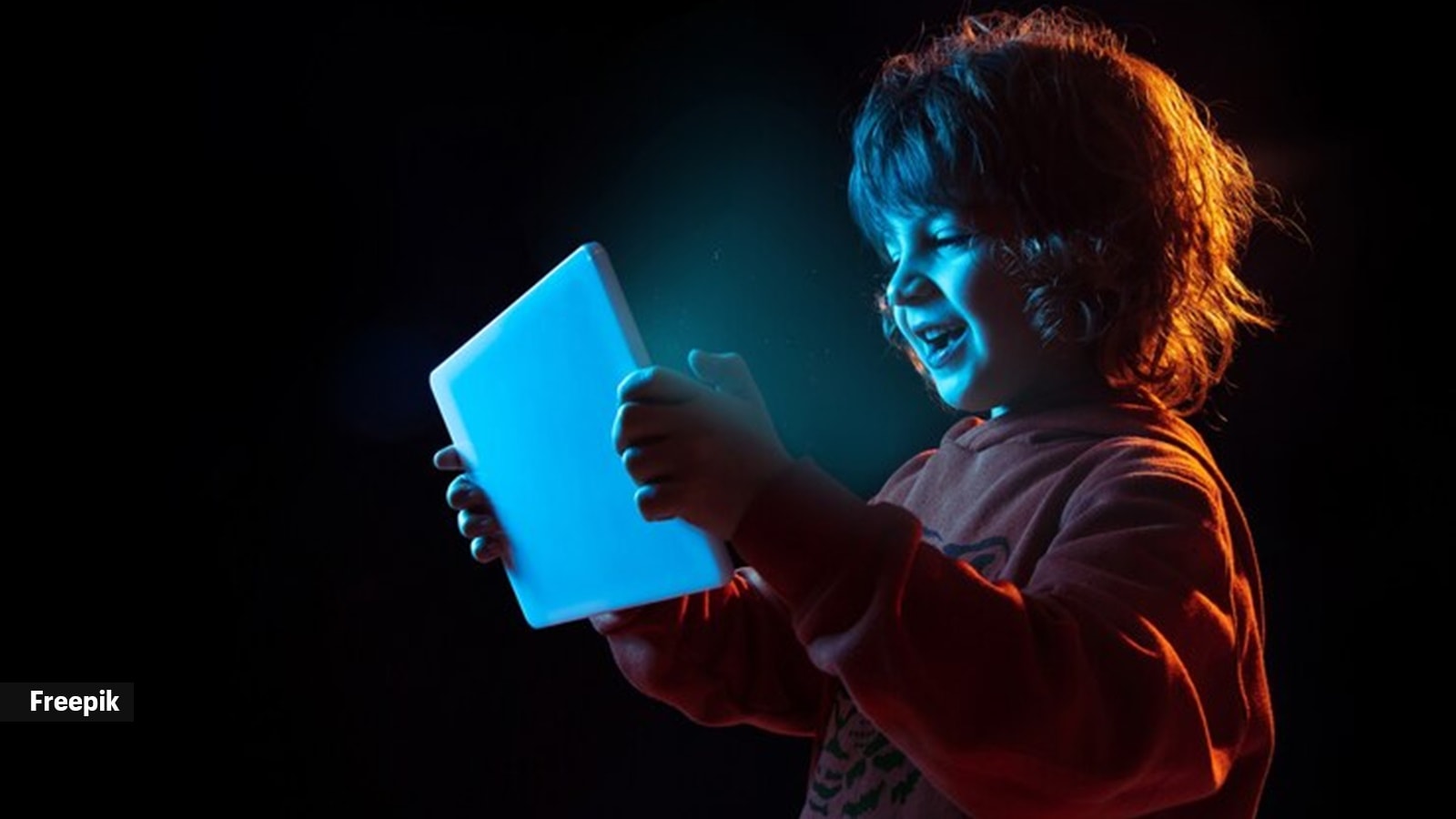 A child interacting with a tablet, representing Generation Beta's integration with technology