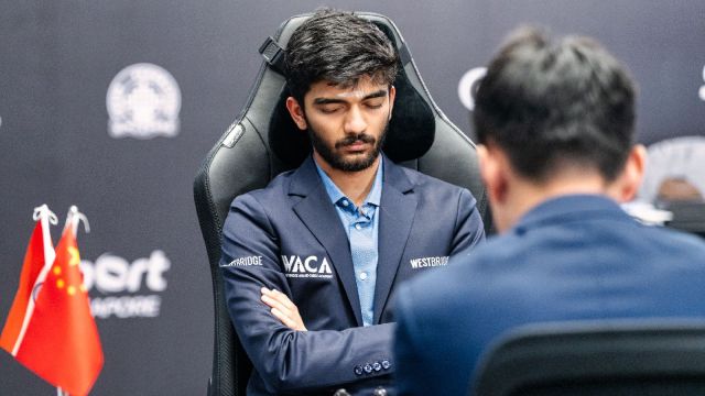 Gukesh meditates in the middle of a World Chess Championship game against world champion Ding Liren. (PHOTO: FIDE via Maria Emelianova)