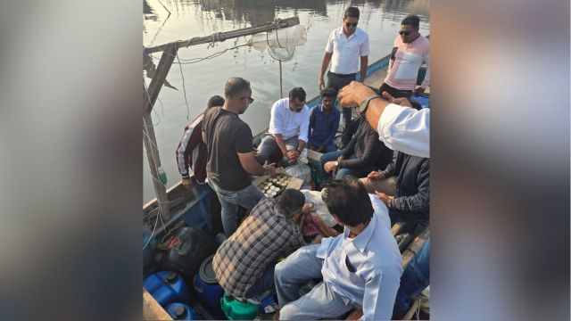 Somnath Marine Police and LCB staff raided the part of the coast where they found two men and the boat filled with liquor. (Express Photo)