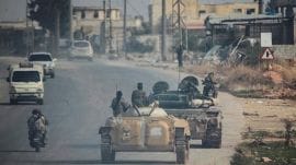 Rebels led by the Islamist militant group Hayat Tahrir al-Sham drive along a street in al-Rashideen, Aleppo province, Syria on November 29. (Reuters File Photo)