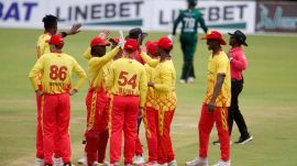 Zimbabwe cricket team in huddle.