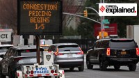 Vehicles pass a sign on 9th Avenue announcing New York City's congestion pricing program on January 6, 2025.