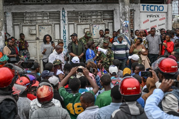 Government soldiers and police officers, right, who surrendered to M23 rebels, left, board trucks to an undisclosed location in Goma, Democratic republic of the Congo, Thursday, Jan. 30, 2025. (AP Photo/Moses Sawasawa)