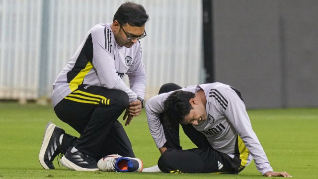 India’s Abhishek Sharma being assisted by a team physiotherapist after hurting his ankle during a practice session ahead of the second T20I cricket match between India and England, at the MA Chidambaram Stadium, in Chennai, Friday, Jan. 24, 2025. The Indian opener faced an injury scare ahead of the T20I match as he twisted his ankle during the catching drill at nets on Friday. (PTI Photo)