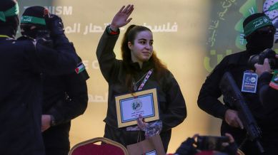 Israeli soldier Agam Berger waves to the crowd as she is handed over to the Red Cross by masked Islamic Jihad militants at the Jabalya refugee camp in Gaza City, Thursday Jan. 30, 2025.(AP Photo/Mohammed Hajjar)