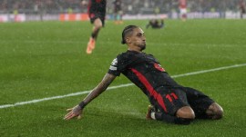 Barcelona's Raphinha celebrates his side's fifth goal during a Champions League opening phase soccer match between SL Benfica and FC Barcelona at the Luz stadium in Lisbon, Tuesday, Jan. 21, 2025. (AP Photo)