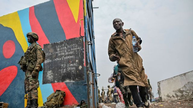 Government soldiers and police officers, right, who surrendered to M23 rebels, left, board trucks to an undisclosed location in Goma, Democratic republic of the Congo, Thursday, Jan. 30, 2025. (AP Photo/Moses Sawasawa)