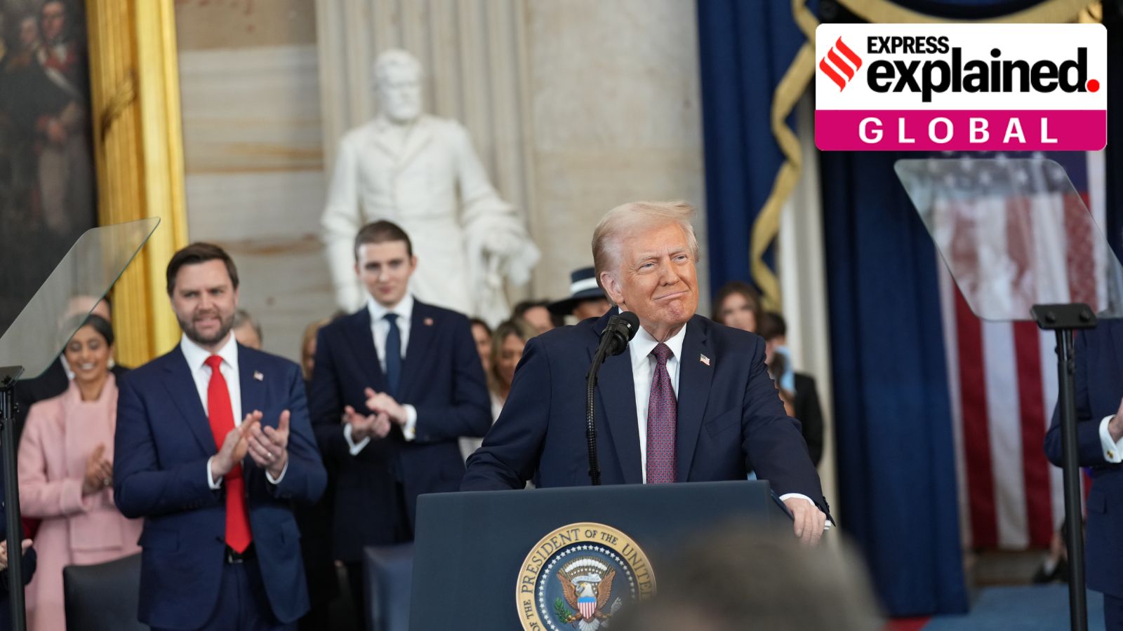 President Donald Trump delivers his inaugural address at his inauguration as the 47th president in the Rotunda at the Capitol in Washington on Monday morning, Jan. 20, 2025. From left: Vice President JD Vance and Barron Trump.