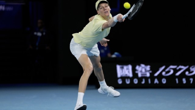 Jannik Sinner of Italy plays a backhand return to Ben Shelton of the U.S. during their semifinal match at the Australian Open tennis championship in Melbourne, Australia, Friday, Jan. 24, 2025. (AP Photo)