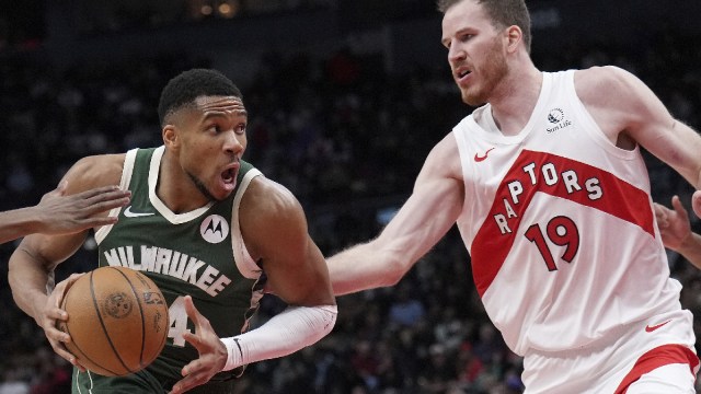 Milwaukee Bucks forward Giannis Antetokounmpo, left, drives past Toronto Raptors center Jakob Poeltl (19) during second-half NBA basketball game action in Toronto, Monday, Jan. 6, 2025. (The Canadian Press via AP)