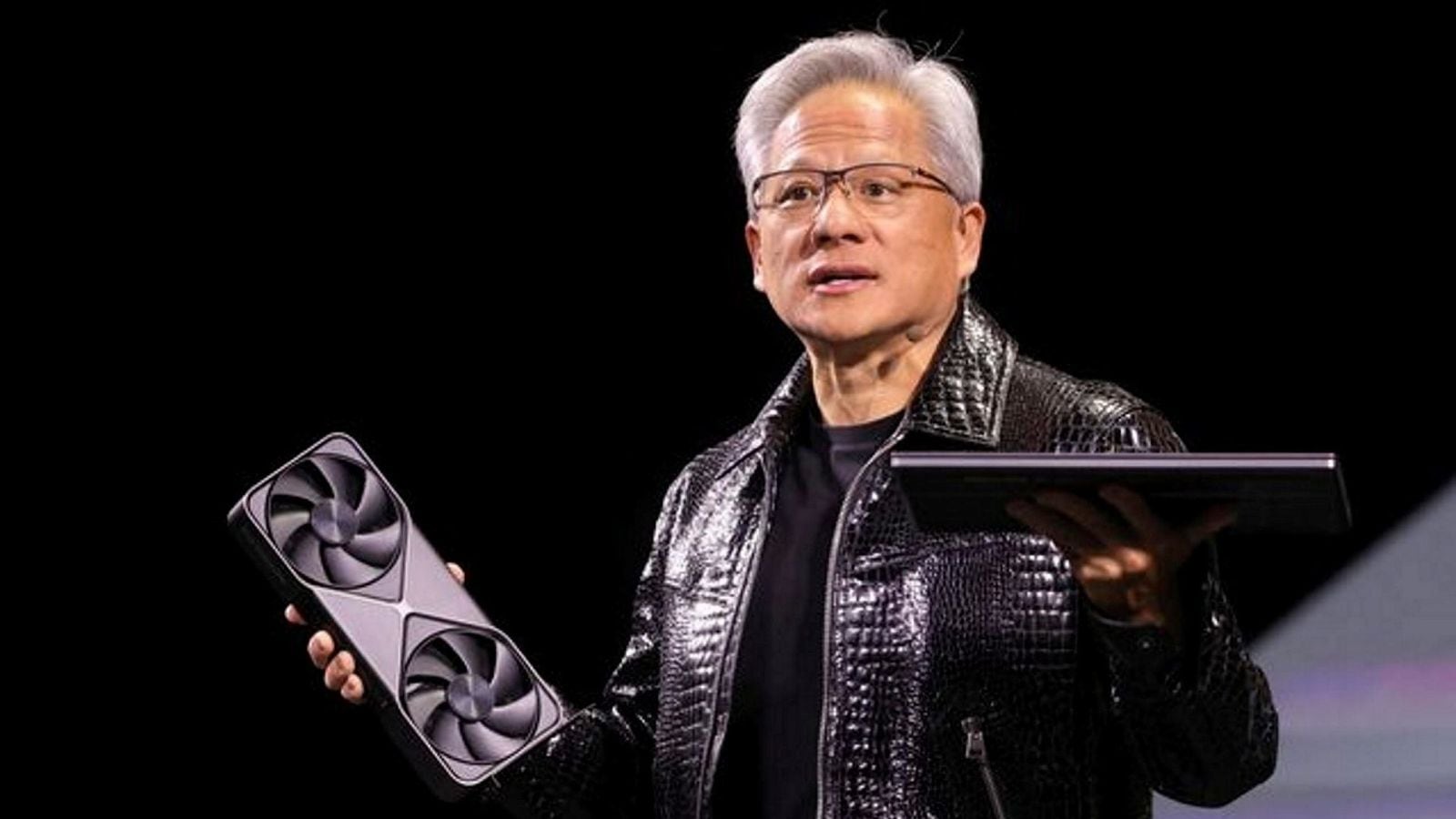 Nvidia CEO Jensen Huang holds a new Nvidia GeForce RTX 5090 graphics card and an RTX 5070 laptop as he gives a keynote address at CES 2025, an annual consumer electronics trade show, in Las Vegas, Nevada, U.S. January 6, 2025.