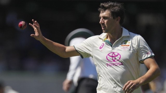 Australia's captain Pat Cummins takes the ball during play on the second day of the fifth cricket test between India and Australia at the Sydney Cricket Ground, in Sydney, Australia. (AP)