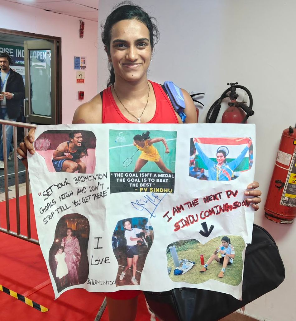 Sindhu poses with a hand-made poster brought to the stadium by a 12-year-old girl that  had Sindhu's photos and one of her own that said 'I am the next Sindhu, coming soon.' (Express Photo)