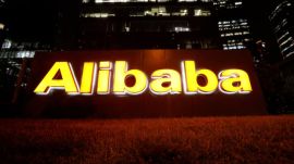 The logo of Alibaba Group is lit up at its office building in Beijing, China August 9, 2021.