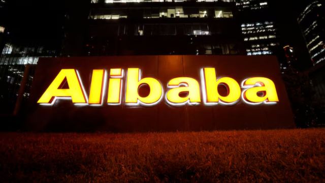 The logo of Alibaba Group is lit up at its office building in Beijing, China August 9, 2021.