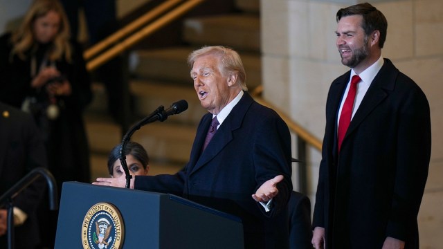 President Donald Trump speaks as Vice President JD Vance watches at Emancipation Hall after the 60th Presidential Inauguration.