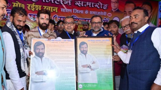 Bihar LJP (RV) Union minister Chirag Paswan welcomes Ayub Khan and Rayees Khan into the party. They are standing together with giant framed photos and Ram Vilas Paswan in hand