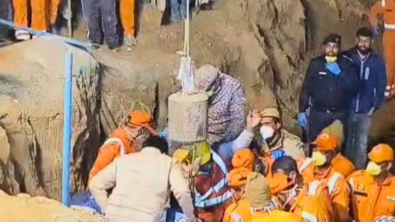 The child was closely wrapped in a white cloth when rescuers pulled her out.