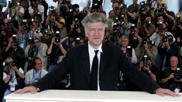 US director David Lynch, President of the Jury at the 55th International Cannes Film Festival, stands in front of a wall of photographers during a photocall in Cannes May 15, 2002. (Reuters File Photo)