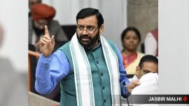 Nayab Singh Saini in Haryana Vidhan Sabha in Chandigarh wearing a blue kurta, a nehru coat and looking on his right with pointed raised finger