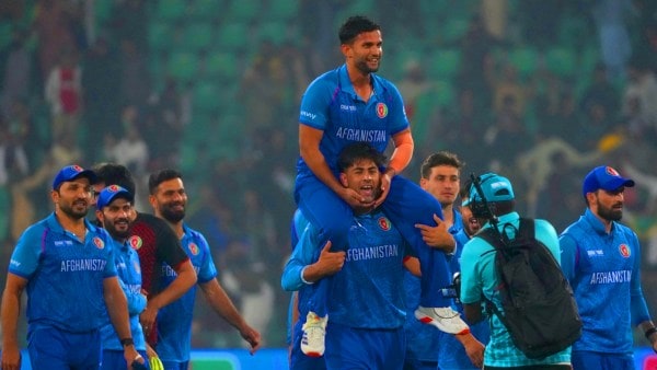 Azmatullah Omarzai rides on the shoulders of an Afghanistan teammate as they celebrate after winning the ICC Champions Trophy cricket match against England in Lahore, Pakistan. (AP Photo)