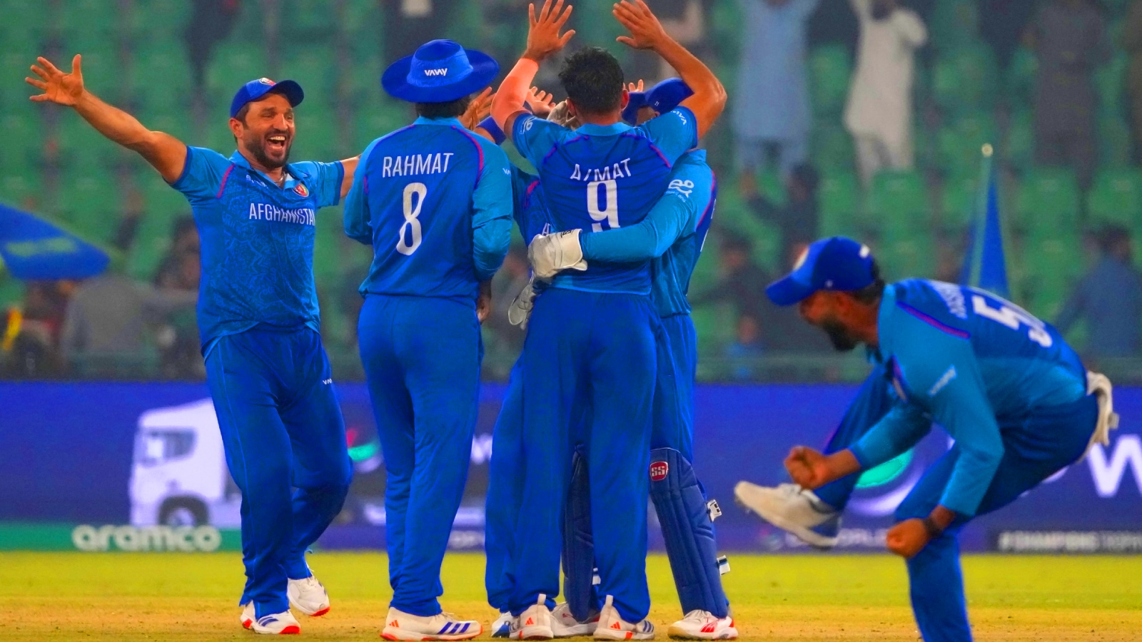 Afghanistan's Azmatullah Omarzai, center, and teammates celebrate after winning the ICC Champions Trophy cricket match against England, in Lahore, Pakistan, Wednesday, Feb. 26, 2025. (AP Photo)