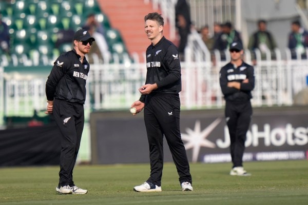 New Zealand's Michael Bracewell, center, chats with Glenn Phillips during the Champions match against Bangladesh. (AP)