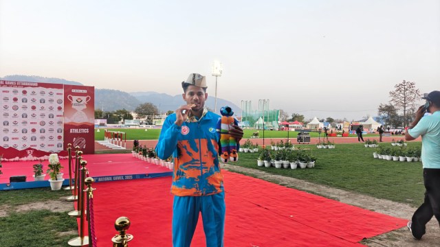 Dev Meena with his gold medal after breaking pole vault NR at National Games. (Express Photo by Pritish Raj)