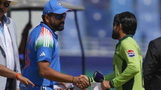 India captain Rohit Sharma with Pakistan's Mohammad Rizwan during the toss at Dubai International Cricket Stadium. (AP)