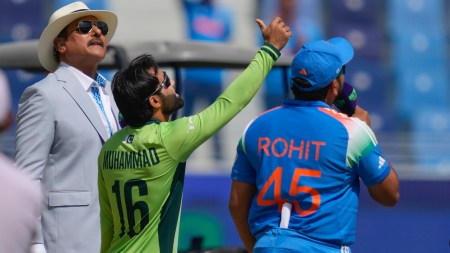 Pakistan's captain Mohammad Rizwan, centre, tosses the coin, as India's captain Rohit Sharma, right, looks on before the start of ICC Champions Trophy cricket match between India and Pakistan at Dubai International Cricket Stadium, United Arab Emirates, Sunday, Feb. 23, 2025. (AP Photo/Altaf Qadri)