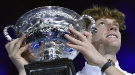 Jannik Sinner of Italy holds the Norman Brookes Challenge Cup aloft after defeating Alexander Zverev of Germany in the men's singles final at the Australian Open tennis championship in Melbourne. (AP Photo)