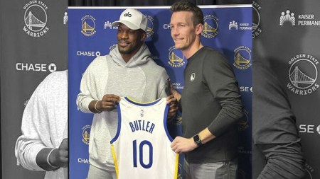 Jimmy Butler, left, displays his new Golden State Warriors jersey alongside general manager Mike Dunleavy at Crypto.com Arena in Los Angeles on Thursday, Feb. 6, 2025. (AP Photo)