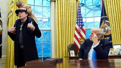 President Donald Trump listens as Elon Musk, joined by his son X Æ A-Xii, speaks in the Oval Office at the White House