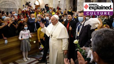 The faithful watch as Pope Francis arrives for a meeting with the Qaraqosh community inside the Church of the Immaculate Conception, in Qaraqosh, Iraq, March 7, 2021.
