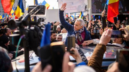 FILE - Calin Georgescu, the winner of Romania's first round of presidential election, annulled by the Constitutional Court, waves to supporters gathered for a protest outside the Romanian parliament in Bucharest, Romania, Saturday, Feb. 22, 2025. (AP Photo/Alexandru Dobre, File)