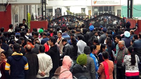 Students and their parents outside the examination centre for JEE Main at an exam centre in Mohali
