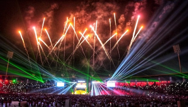 Fireworks light up the sky during ‘Jhumoir Binandini,’ an attempt to set a world record for the largest participation in a Jhumoir dance event. (PTI Photo)