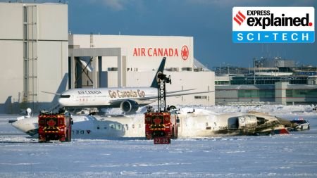 The wreckage of a Delta Air Lines passenger jet lies upside down on the tarmac after a crash landing at Toronto Pearson International Airport in Toronto on Monday, Feb. 17, 2025. Authorities are investigating the cause of the accident, which occurred amid strong winds and drifting snow. (Ian Willms/The New York Times)