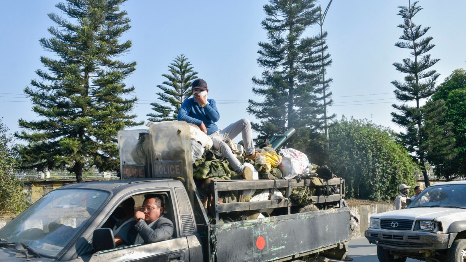 Convoy of security personnel and members of Arambai Tenggol arrive at 1st Manipur Rifles Battalion Ground to hand over looted and illegally held arms and ammunition to security officials, in Imphal on Thursday. (ANI Photo)