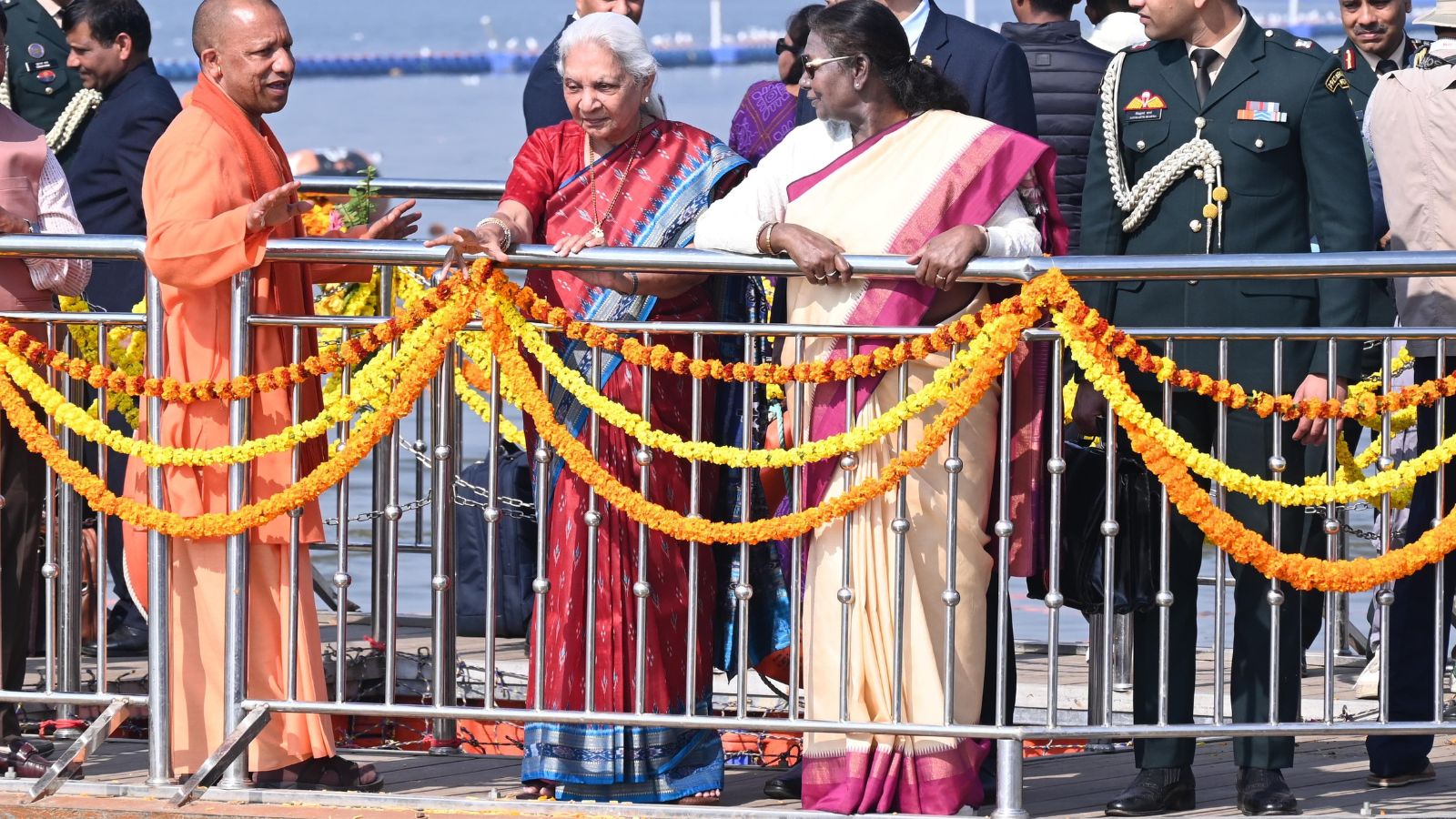 President Droupadi Murmu with Governor Anandiben Patel and Chief Minister Yogi Adityanath, in Prayagraj Monday. (PTI Photo)