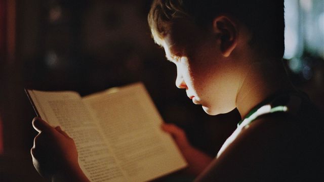 student reading a book aser