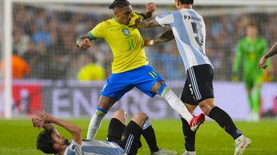 Argentina's Leandro Paredes pushes Brazil's Raphinha during a World Cup 2026 qualifying soccer match at Monumental Stadium in Buenos Aires. (AP Photo)