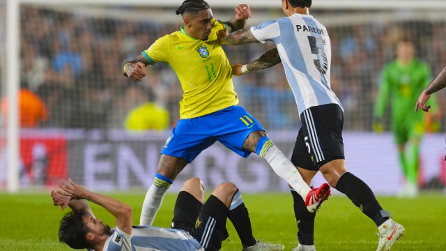 Argentina's Leandro Paredes pushes Brazil's Raphinha during a World Cup 2026 qualifying soccer match at Monumental Stadium in Buenos Aires. (AP Photo)