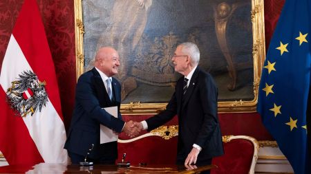 Austrian President Alexander Van der Bellen, right, shakes hands with Chancellor Christian Stocker during the swearing-in ceremony of the Federal Government in the presidential office at the Hofburg Palace, in Vienna, Austria, Monday, March 3, 2025. (AP Photo/Denes Erdos)